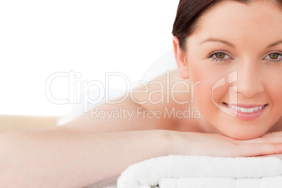 Attractive red-haired woman posing while relaxing in a spa centr