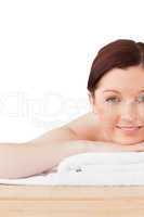 Good looking red-haired woman posing while relaxing in a spa cen