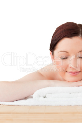 Charming red-haired woman posing while relaxing in a spa centre