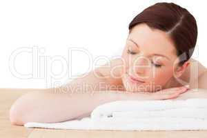 Pretty red-haired woman posing while relaxing in a spa centre
