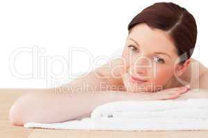 Young pretty red-haired woman posing while relaxing in a spa cen