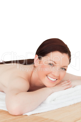 Happy red-haired woman posing while relaxing in a spa centre