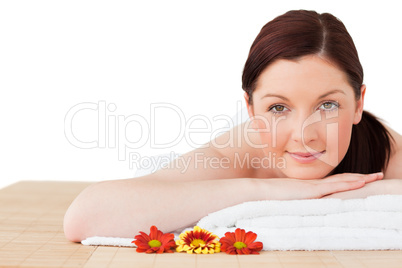 Portrait of a good looking red-haired woman posing while relaxin