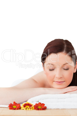 Portrait of a cute red-haired woman posing while relaxing in a s