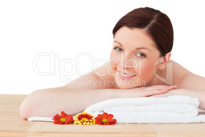 Portrait of a charming red-haired woman posing while relaxing in