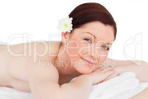 Portrait of a happy red-haired woman posing while relaxing in a
