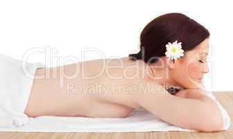 Portrait of a pretty serene woman posing while relaxing in a spa