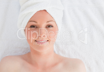 Closeup of a pretty serene woman posing while relaxing in a spa