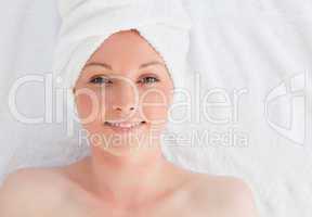 Closeup of a pretty serene woman posing while relaxing in a spa