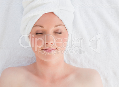 Closeup of a beautiful serene woman posing while relaxing in a s