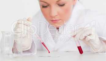 Beautiful female scientist holding a test tube