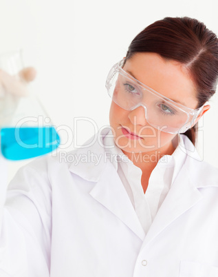 Beautiful scientist holding a beaker in a laboratory