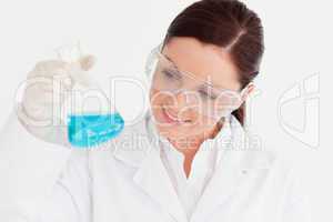 Good looking scientist holding a beaker in a laboratory