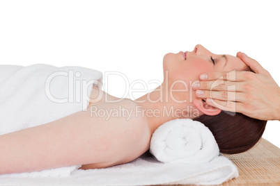 Closeup of a young serene woman posing while relaxing in a spa c