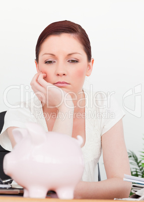 Young pensive female thinking while sitting in an office