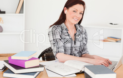 Attractive joyful girl relaxing with a laptop