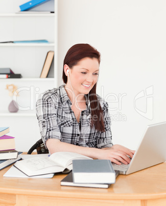 Pretty joyful girl relaxing with a laptop