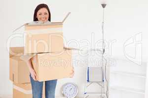 Attractive red-haired woman holding some carboard boxes