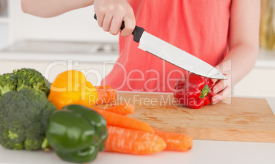 Woman cutting some vegetables in the kitchen