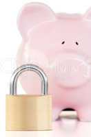 Close up of a pink piggy bank and padlock