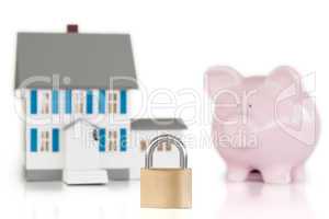 House locked with padlock and piggy bank