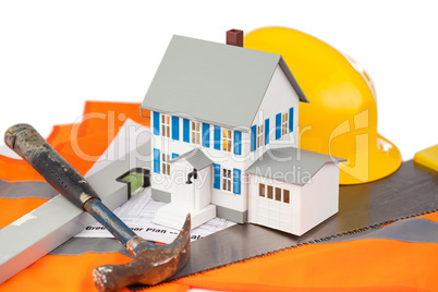 Tools and miniature house on an orange jacket