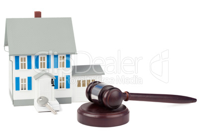 Grey toy house model with a key and a brown gave