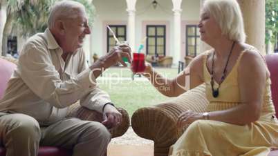 Old man and woman drinking in hotel bar