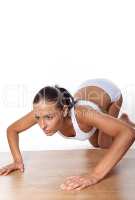 Young Woman Doing Pushups isolated on white