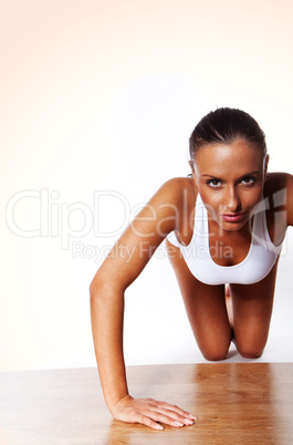 smiling Young Woman Doing Pushups isolated on white