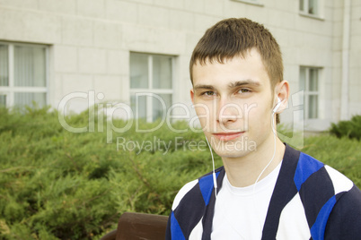 Closeup of a young male student in the headphones