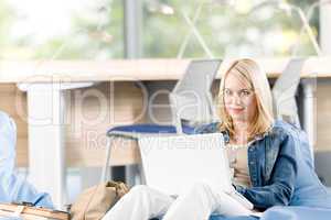 Young happy high-school student relax with laptop