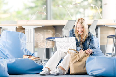 Young happy high-school student relax with laptop