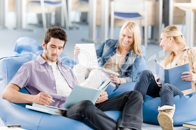 Group of high-school students with books sitting