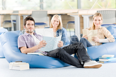 Group of high-school students with books sitting