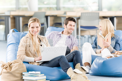Group of high-school students with books sitting