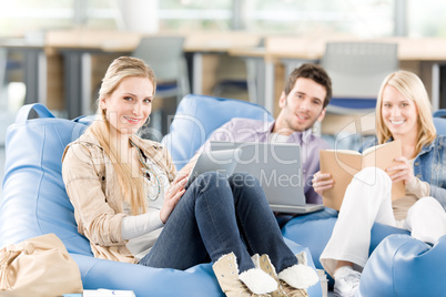 Group of high-school students with books sitting