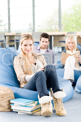 Group of high-school students with books sitting