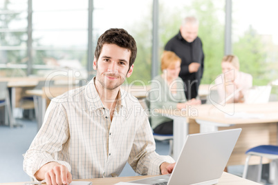 Portrait of young businessman with team in back