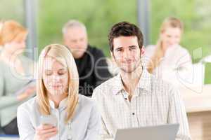 Two young student businesspeople in office