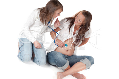 Beautiful pregnant woman with daughter