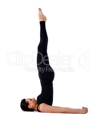 Yong woman doing yoga - sarvangasana isolated