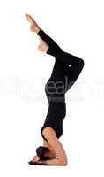 Yong woman exercise yoga asana - headstand