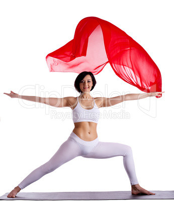 woman stand in yoga asana and red flying fabric