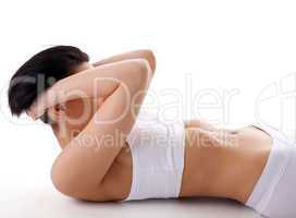 Young woman in white yoga exercise with stomach