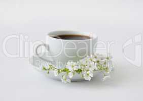 A cup of black coffee with flowers