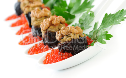 Prunes stuffed with liver pate with nuts in a red caviar