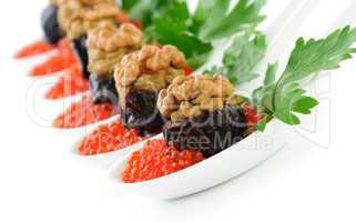 Prunes stuffed with liver pate with nuts in a red caviar