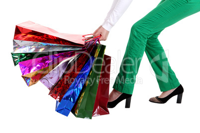 Beautiful stylish woman pulling shopping bags