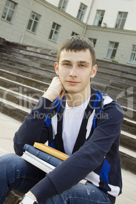 Male student on campus with textbooks